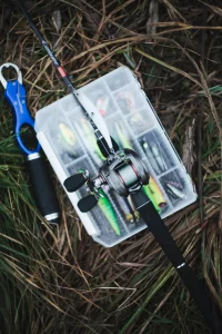 fishing-rod-fishing-lure-transparent-plastic-box-grass 1